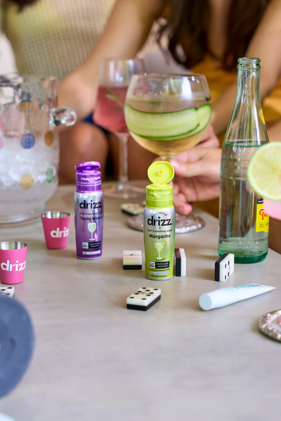 A table of drinks with Drizz bottles ready to mix