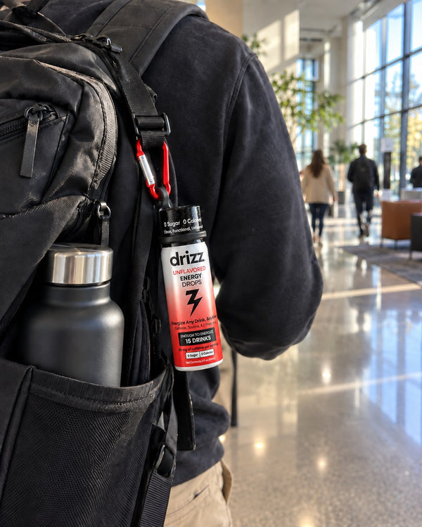 Drizz Energy Drops clipped to a backpack in an office lobby