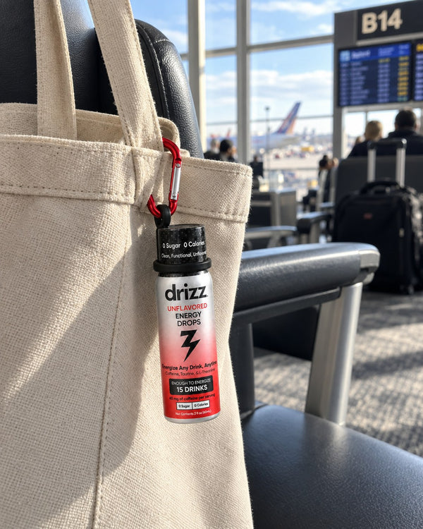 Drizz Energy Drops clipped to a tote bag at an airport gate