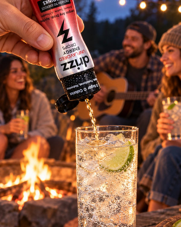 Squeezing Drizz Energy Drops into sparkling water by a campfire