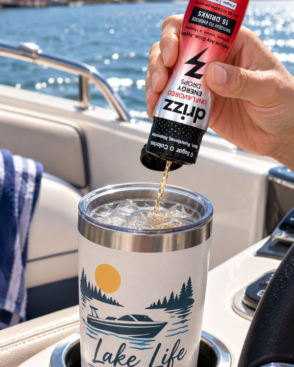 Squeezing Drizz Energy Drops into a tumbler on a lake boat