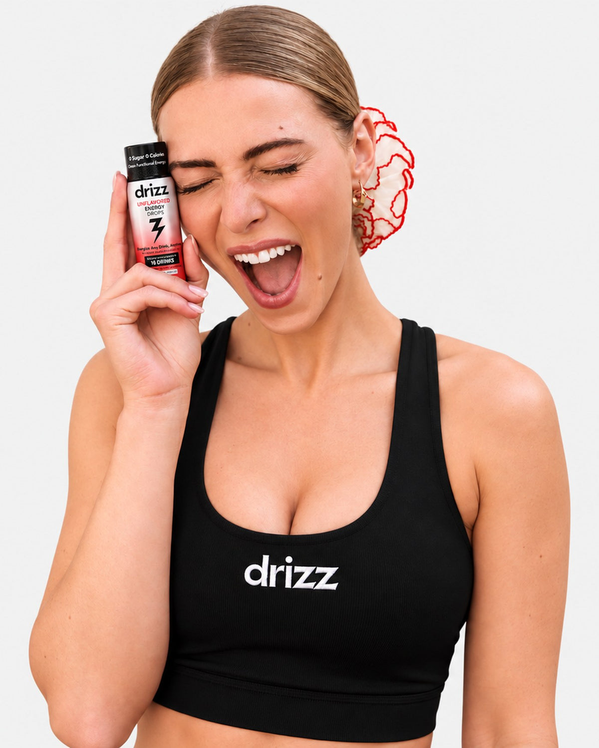 Laughing with a bottle of Drizz Unflavored Energy Drops