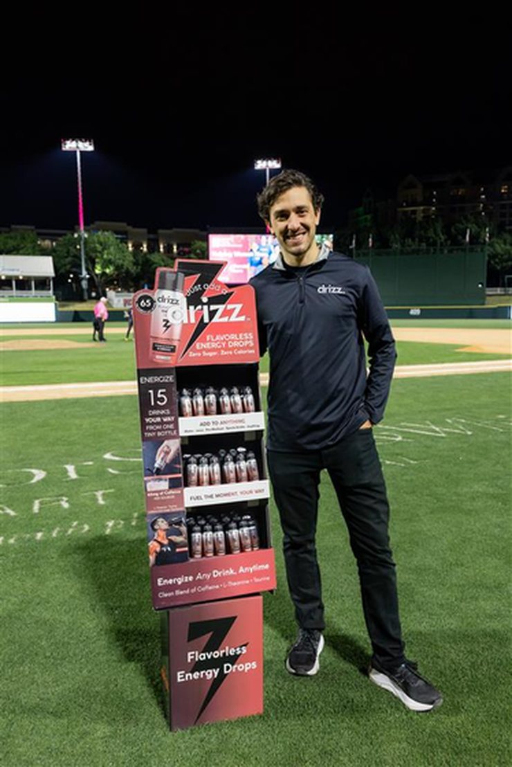 Rodrigo Ricaud, founder of Drizz, beside a Drizz display